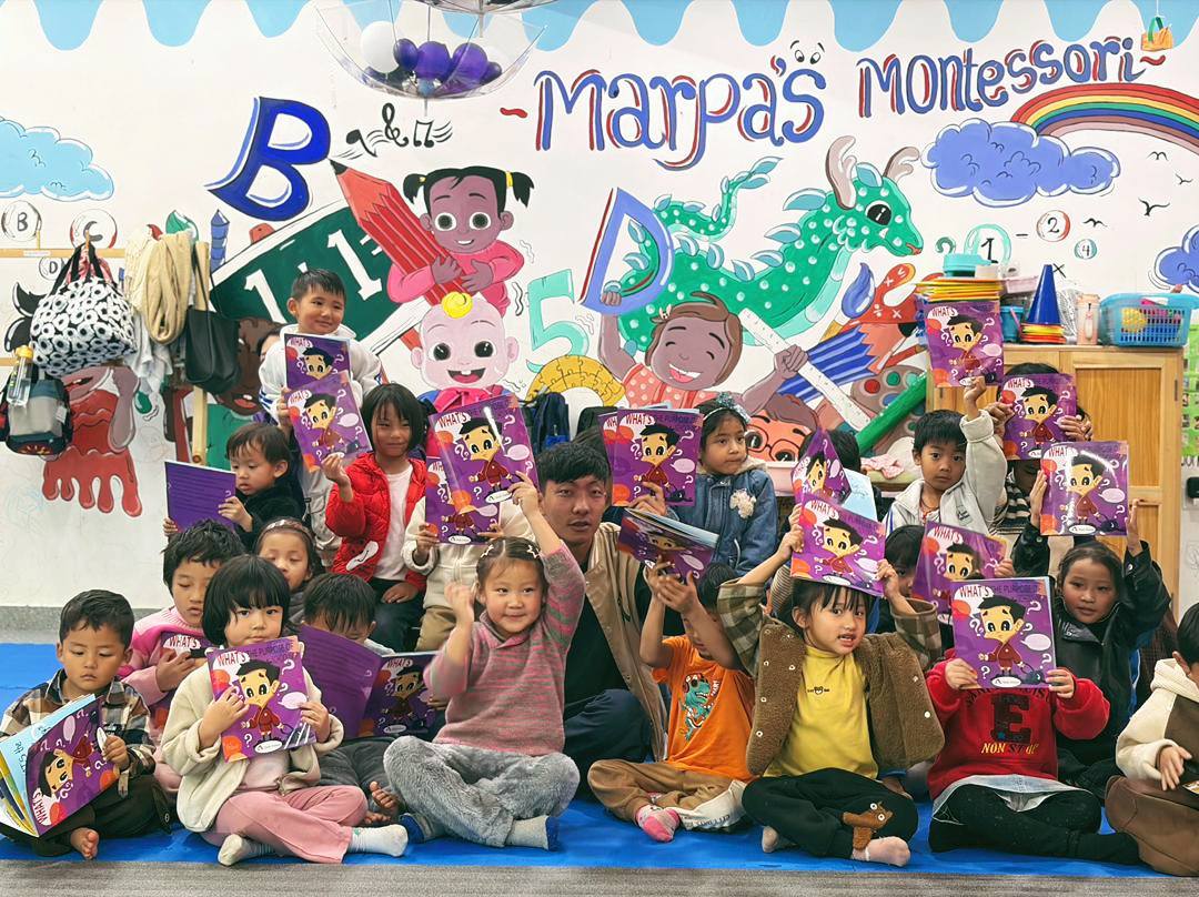 Children at Marpa's Montessori holding books
